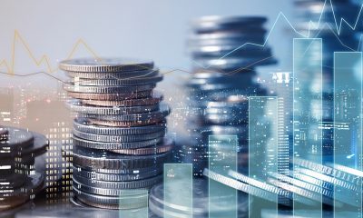 Double exposure of graph and rows of coins for finance and business concept